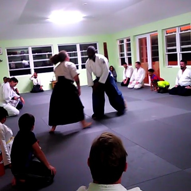 Sensei Smith using Signe to test out how the new mats feel at tonight’s opening class #bermudaaikikai #bermuda #aikido #aikikai #breakfall #aikidowoman #newdojo #newmats #martialarts #aikidovideo #6thdan #rokudan #2nddan #nidan