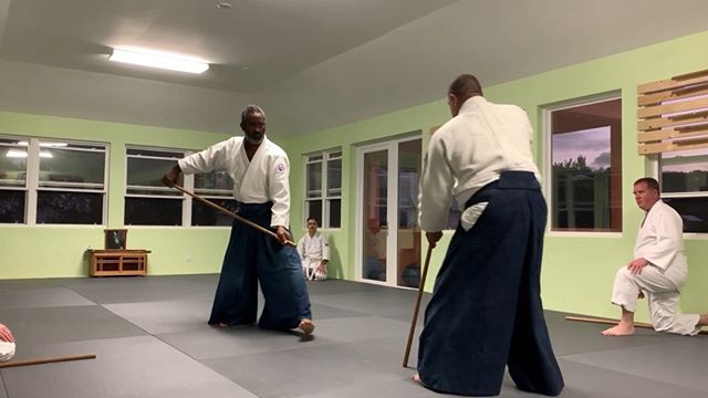 Sensei Smith demonstrates jo techniques, with Eugene during Wednesday night weapons at Bermuda Aikikai.